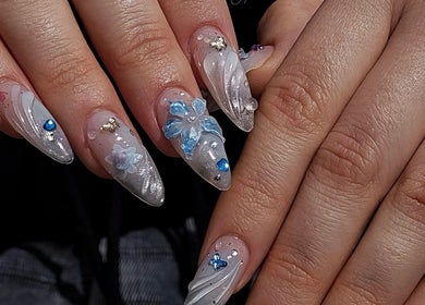 Intricate floral nail art with blue accents at Pressed Beans, Montréal, Québec, CA.