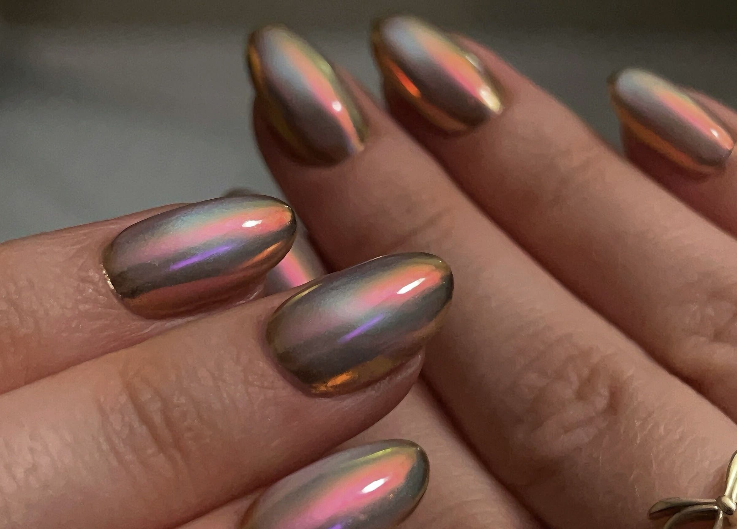 Beautiful iridescent manicure at Pressed Beans, Montréal, Québec, CA, showcasing glossy, colorful nails.