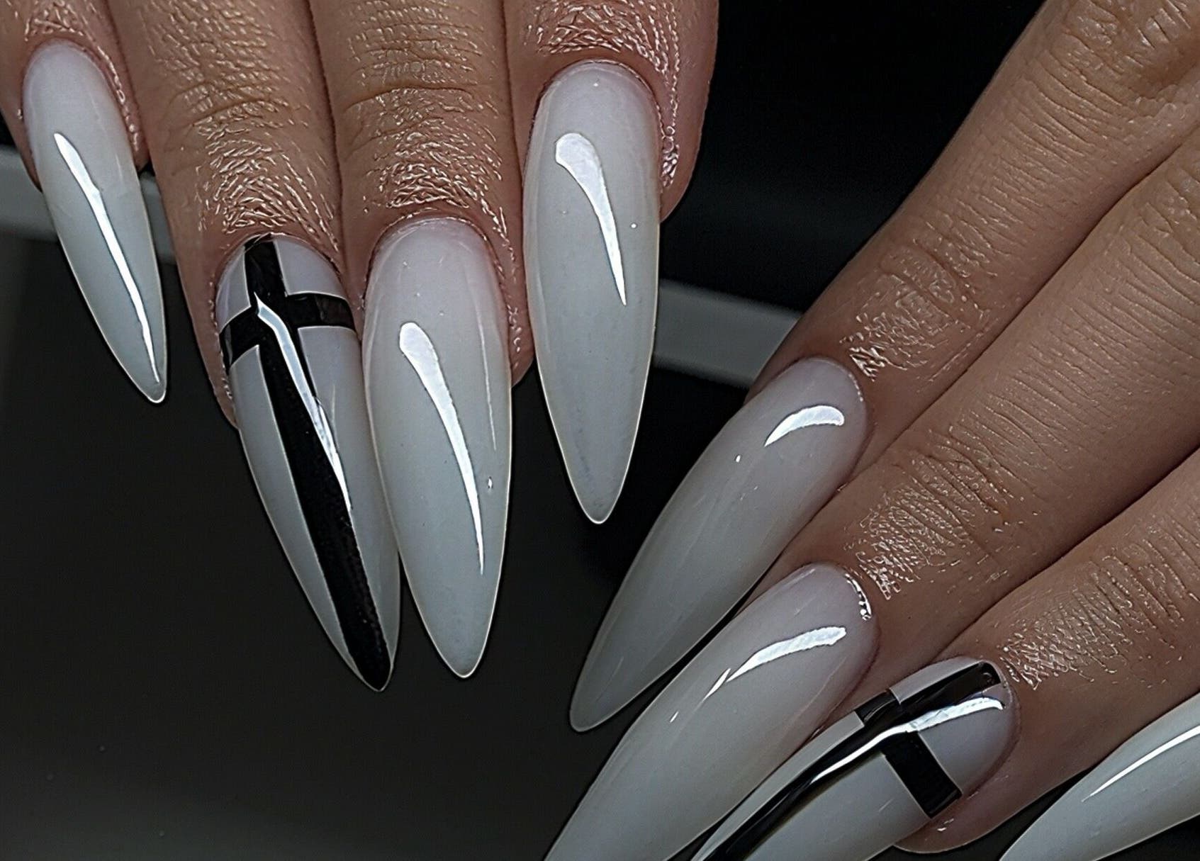 Elegant stiletto nails at Pressed Beans in Montréal, Québec, CA with black and white design.