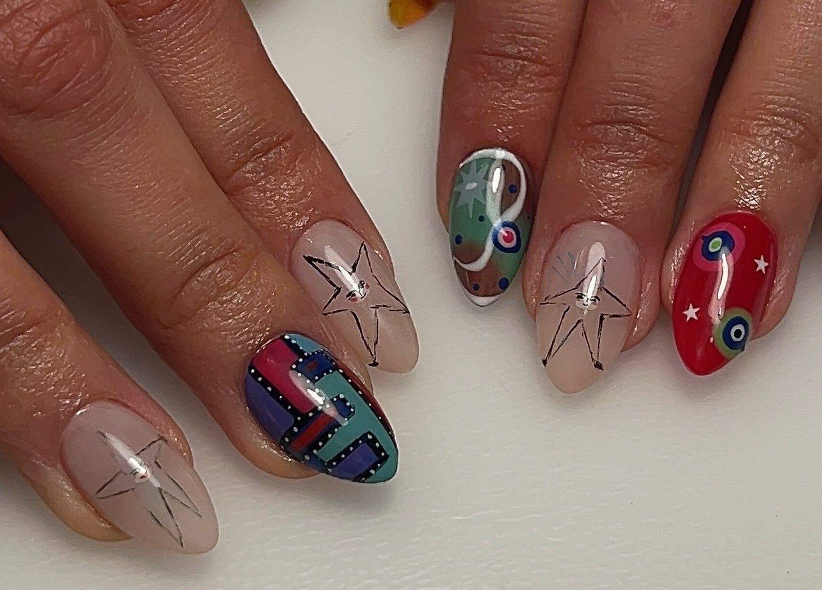 Colorful artistic nails at Pressed Beans, Montréal, Québec, CA showcasing intricate designs and vibrant patterns.