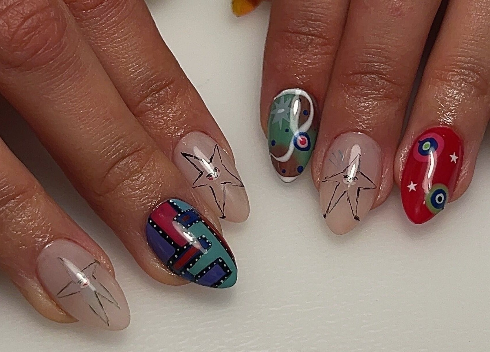 Colorful artistic nails at Pressed Beans, Montréal, Québec, CA showcasing intricate designs and vibrant patterns.