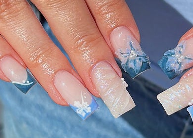 Blue floral nail art on manicured hands at Gracie’s Nail Lab, West Bromwich, England, GB.