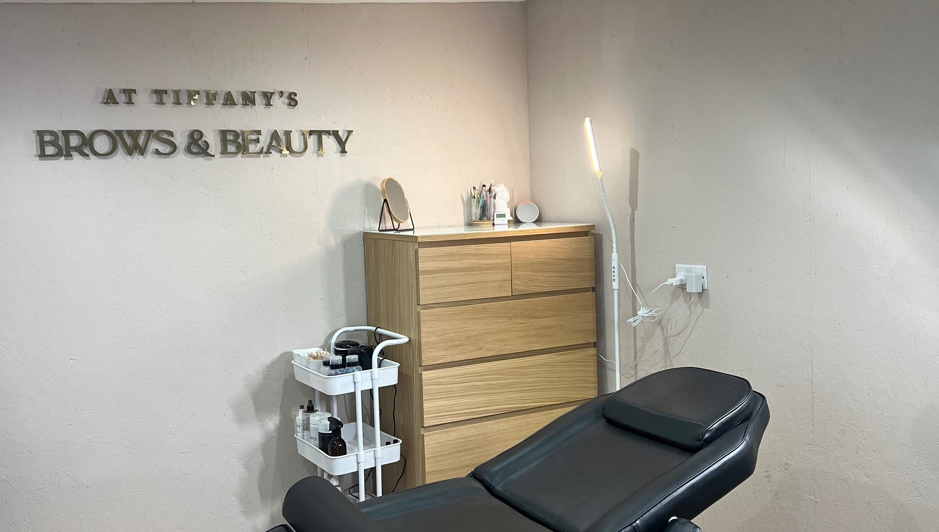 Relaxing treatment room at Tiffany’s Brows and Beauty, Northam, England, GB. Modern decor with a treatment chair.