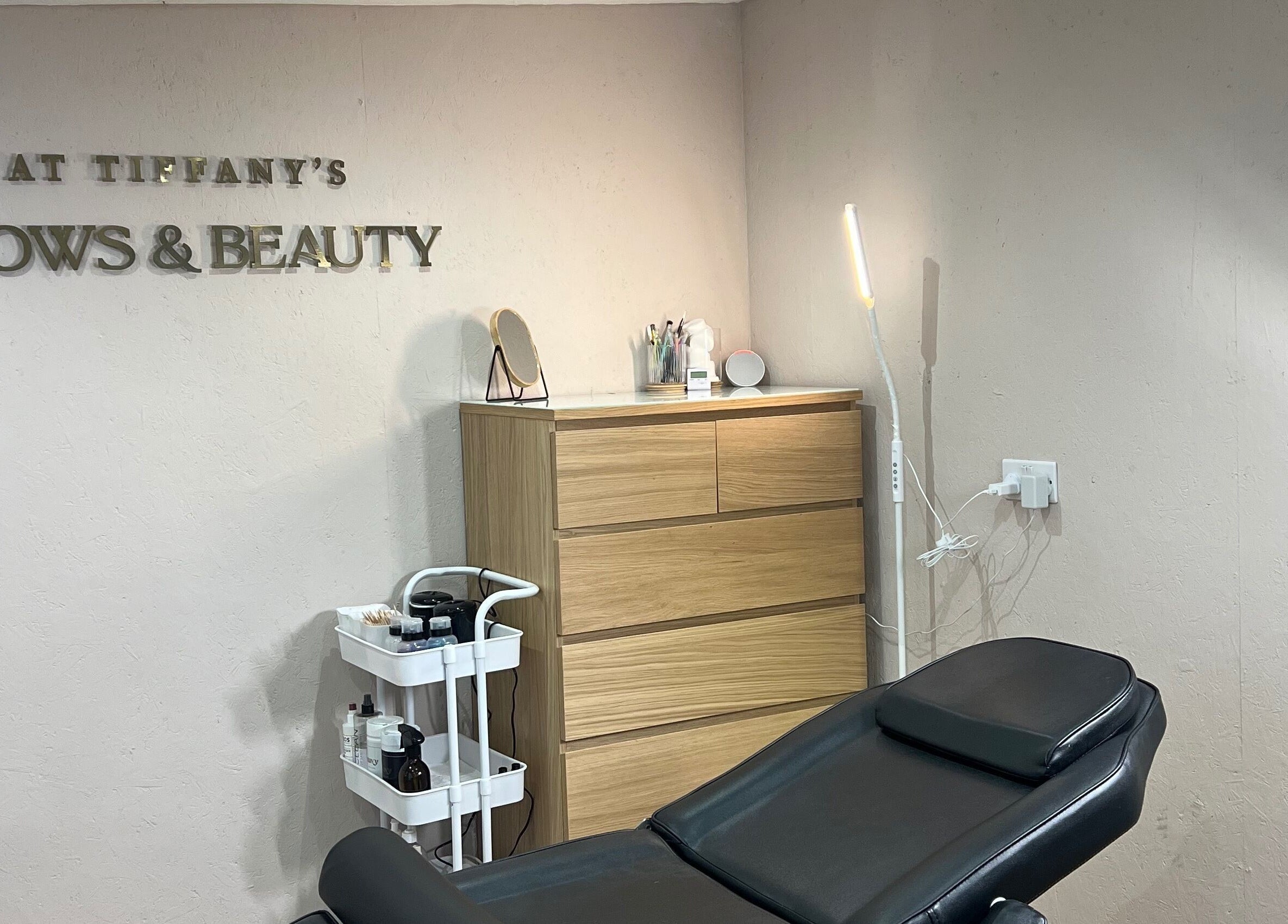 Relaxing treatment room at Tiffany’s Brows and Beauty, Northam, England, GB. Modern decor with a treatment chair.