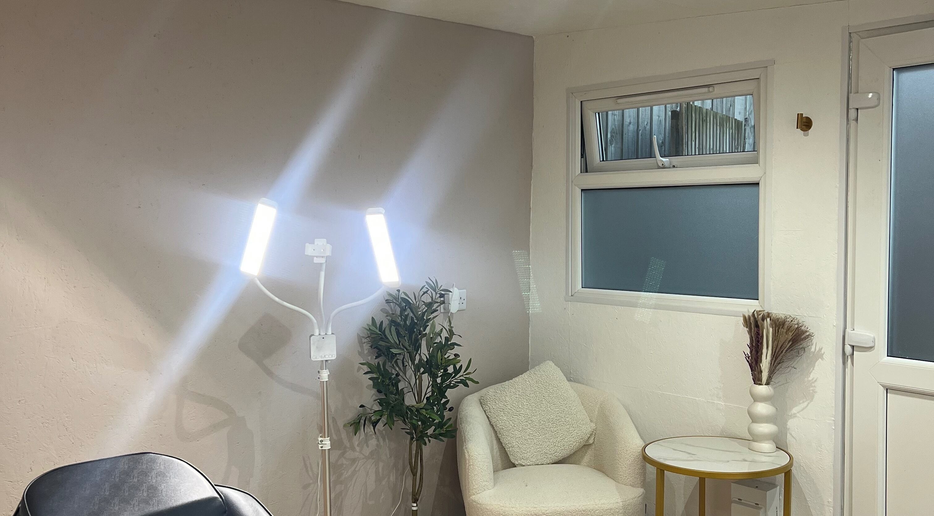 Inviting beauty corner at Tiffany’s Brows and Beauty, Northam, England, GB. Modern lighting and seating setup.