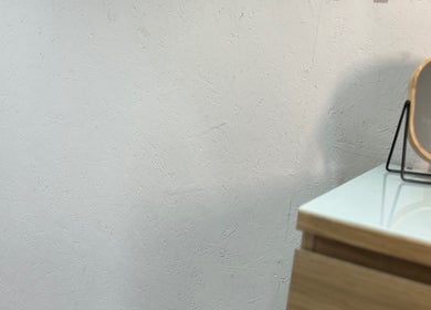 Minimalist wooden vanity and mirror at At Tiffany’s Brows and Beauty, Northam, England, GB.