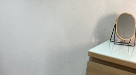 Minimalist wooden vanity and mirror at At Tiffany’s Brows and Beauty, Northam, England, GB.