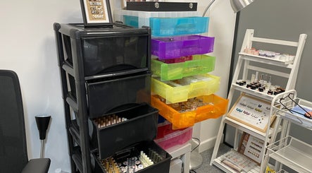 Organized nail supply racks at Pineapple Chuncks Nail, Manchester, England, GB showcasing tools and accessories.