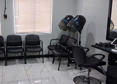 Modern salon interior at Jaycee's Beauty Empire, Petit Valley, with chairs and styling equipment.