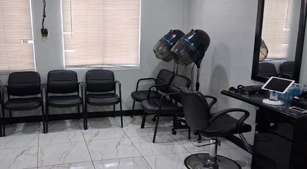 Modern salon interior at Jaycee's Beauty Empire, Petit Valley, with chairs and styling equipment.