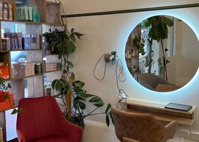 Chic hair salon interior at Olive For Hair, Mount Barker, Western Australia, AU, featuring stylish seating and plants.