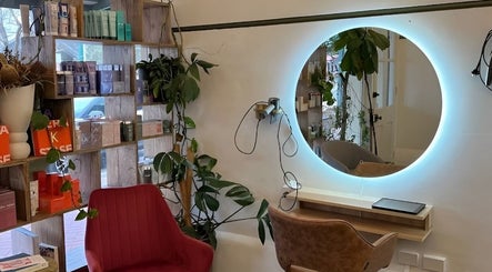 Chic hair salon interior at Olive For Hair, Mount Barker, Western Australia, AU, featuring stylish seating and plants.