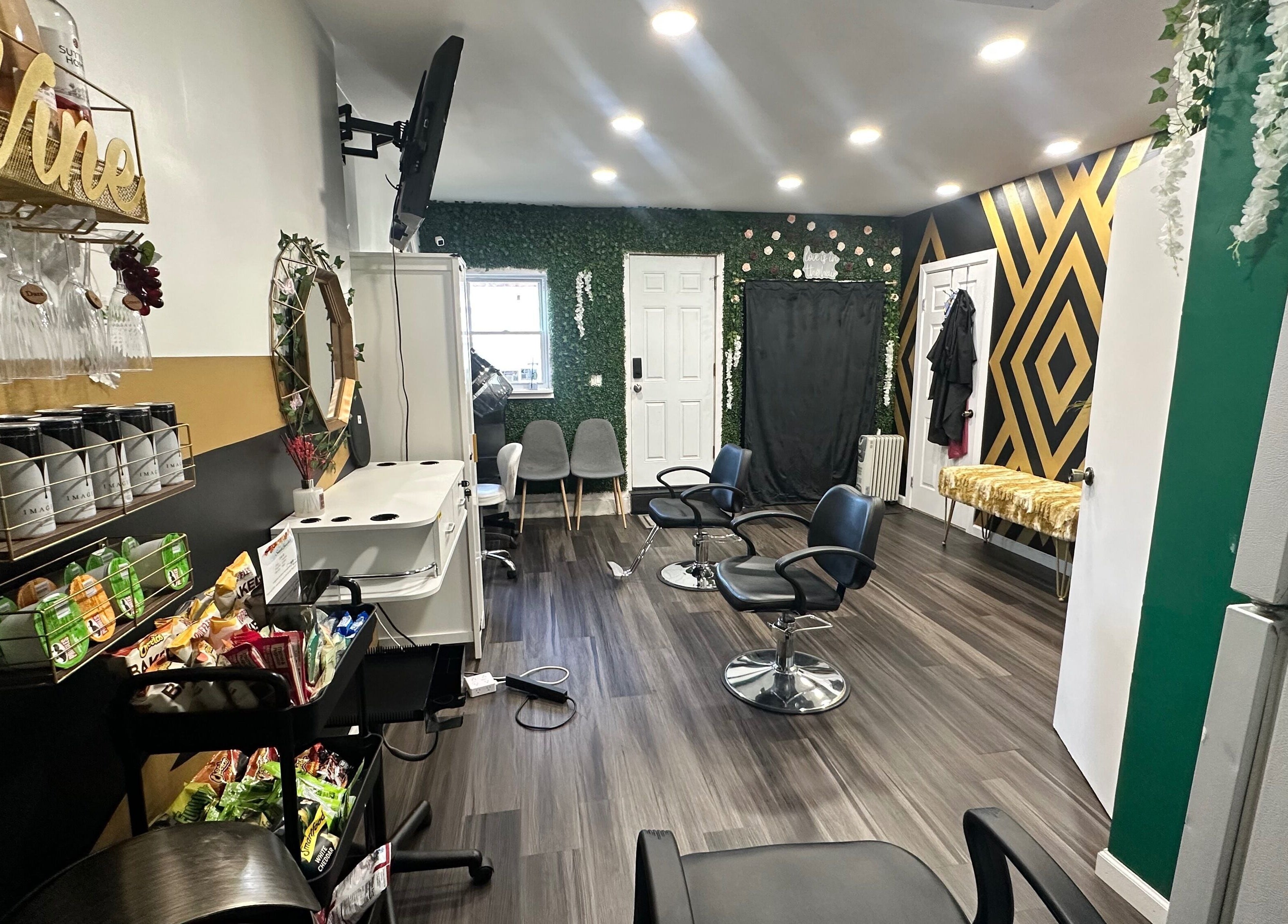 Elegant salon space at Laid Gracefully LLC, New York, New York, US with stylish chairs and geometric accent wall.