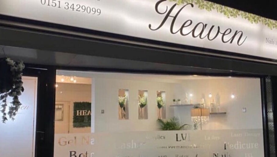 Exterior of Dew Skin Aesthetics, Heswall, England, GB at night with illuminated signage and modern decor.