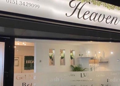 Exterior of Dew Skin Aesthetics, Heswall, England, GB at night with illuminated signage and modern decor.