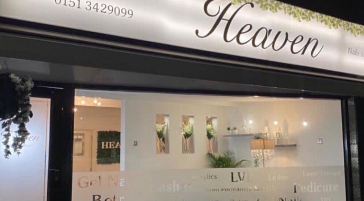 Exterior of Dew Skin Aesthetics, Heswall, England, GB at night with illuminated signage and modern decor.