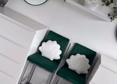 Green chairs with shell pillows at Dew Skin Aesthetics, Heswall, England, GB enhance the calm ambiance.
