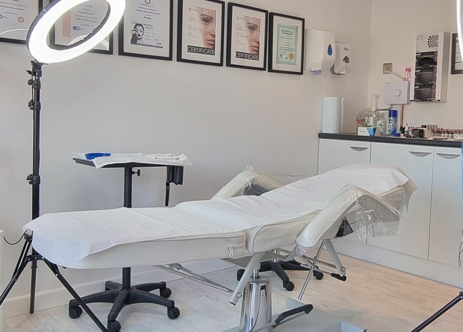 Bright treatment room at Enhance Your Glow in Penryn, England, GB with modern equipment and decor.
