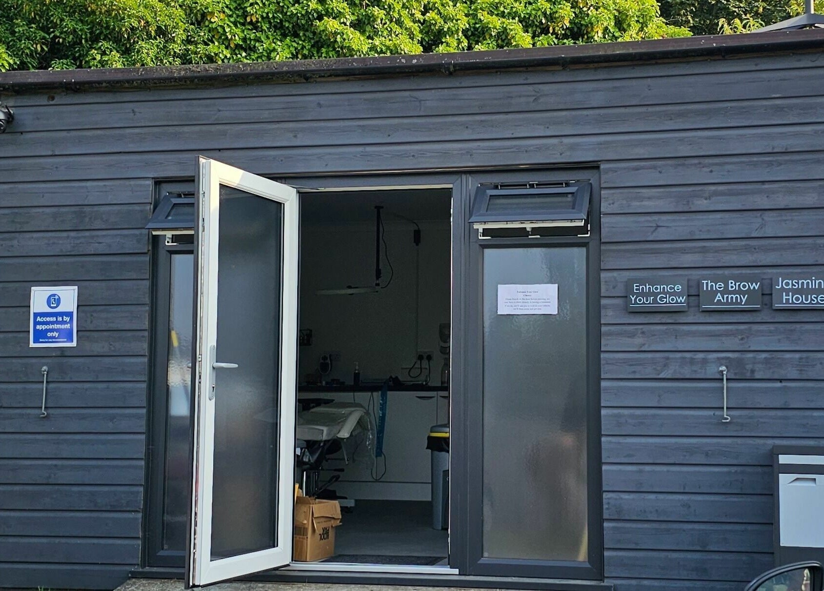 Entrance of Enhance Your Glow, Penryn, England. Contemporary design with open door inviting visitors.