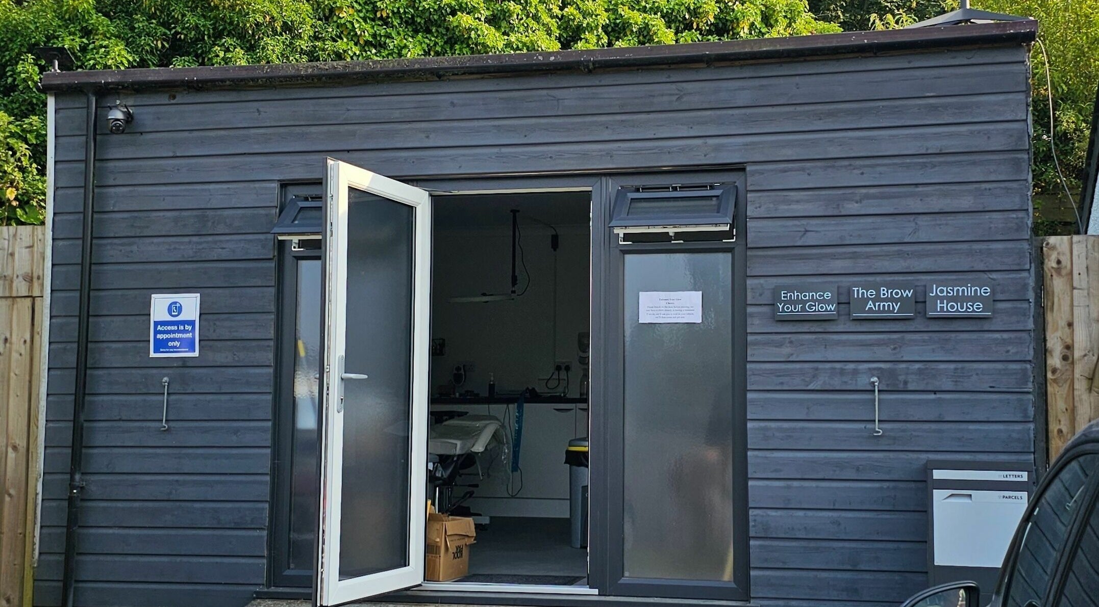 Entrance of Enhance Your Glow, Penryn, England. Contemporary design with open door inviting visitors.
