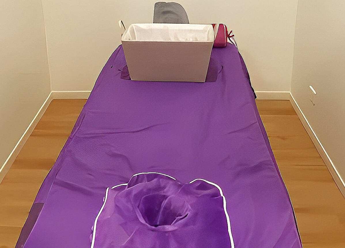 Relaxing massage table with purple cover at Healing Hands Massage & Acupuncture, Brassall, Queensland, AU.