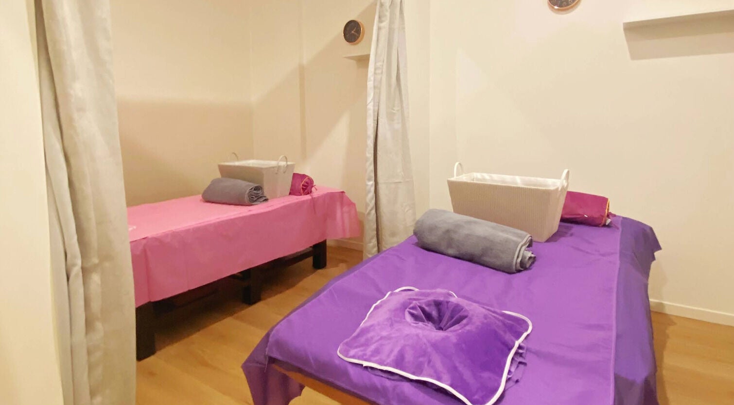 Calm massage room at Healing Hands Massage & Acupuncture in Brassall, Queensland, AU with two prepared beds.