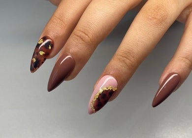 Stylish manicured nails with gold accents at Maria's Studio, Gqeberha, Eastern Cape, ZA.