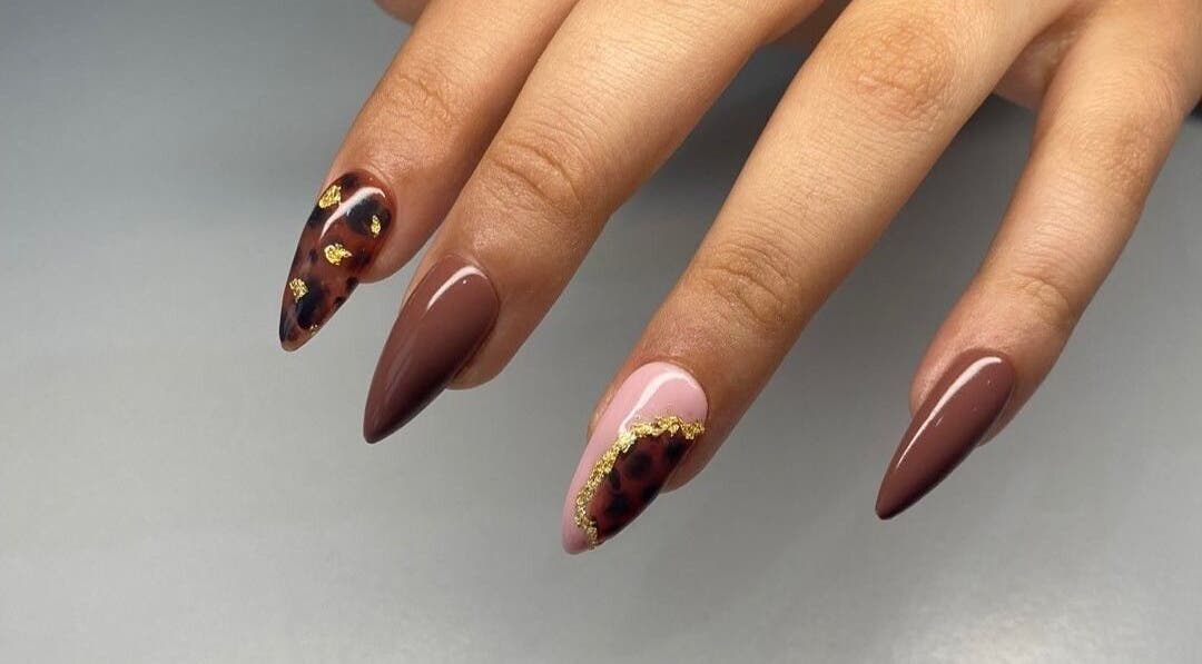 Stylish manicured nails with gold accents at Maria's Studio, Gqeberha, Eastern Cape, ZA.