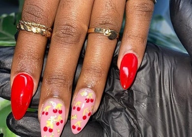 Elegant cherry nail art at Maria's Studio, Gqeberha, Eastern Cape, ZA, showcasing vibrant design.