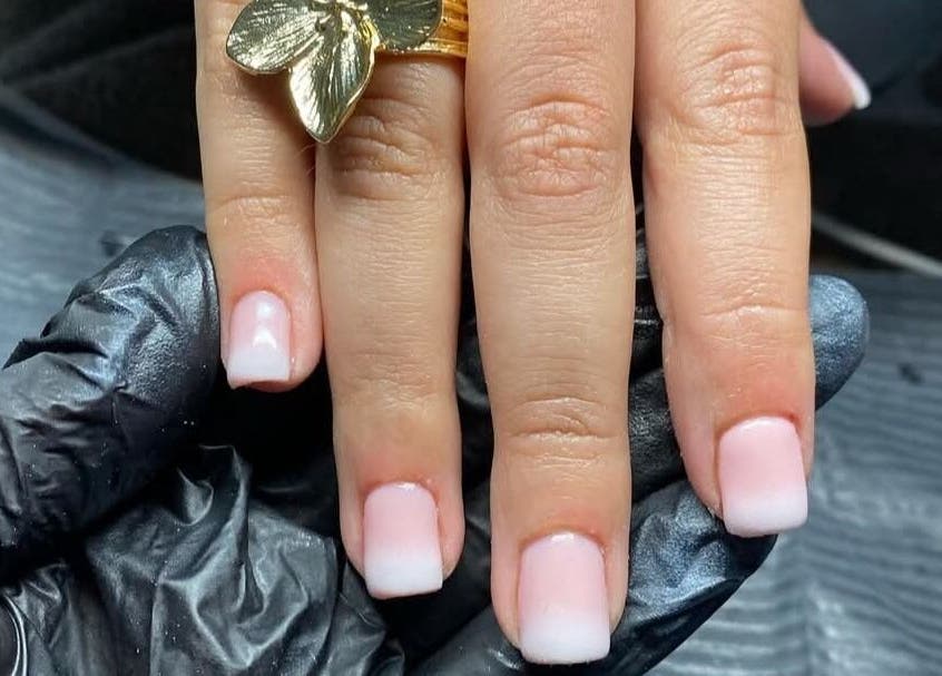 French manicure at Maria's Studio in Gqeberha, Eastern Cape, ZA showcasing delicate artistry.