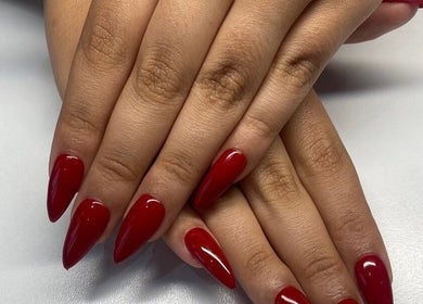 Elegant red manicure at Maria's Studio in Gqeberha, Eastern Cape, ZA, showcasing stylish nail design.