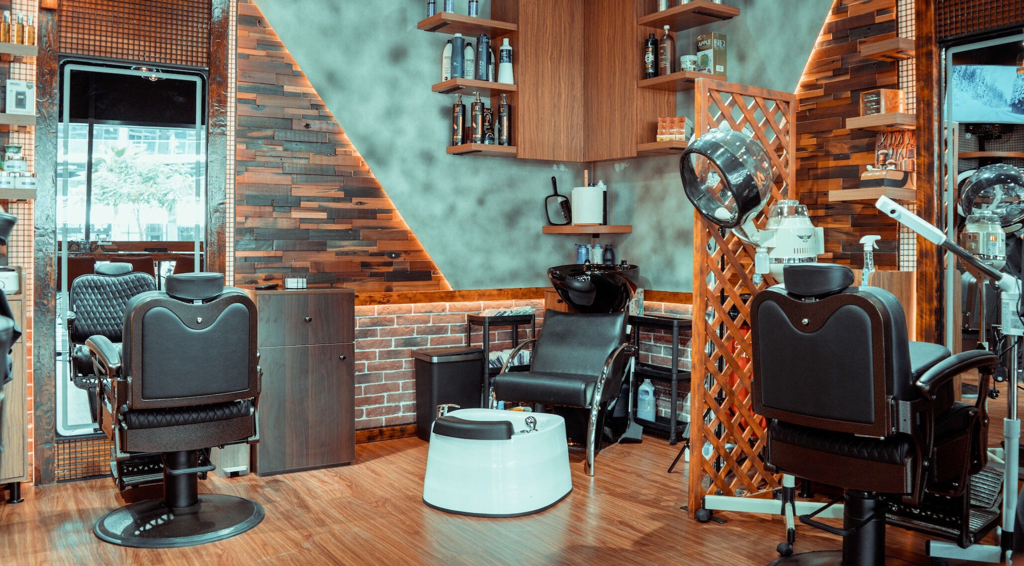 Chic interior of Amici Gents Salon, Dubai, Dubai, AE featuring stylish barber chairs and wood accents.