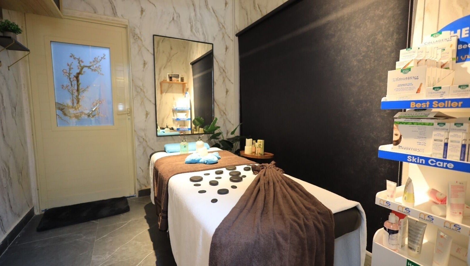 Peaceful therapy room at Leaders Palace Gents Care Facility in Sharjah, Sharjah, AE with massage table and skin care.