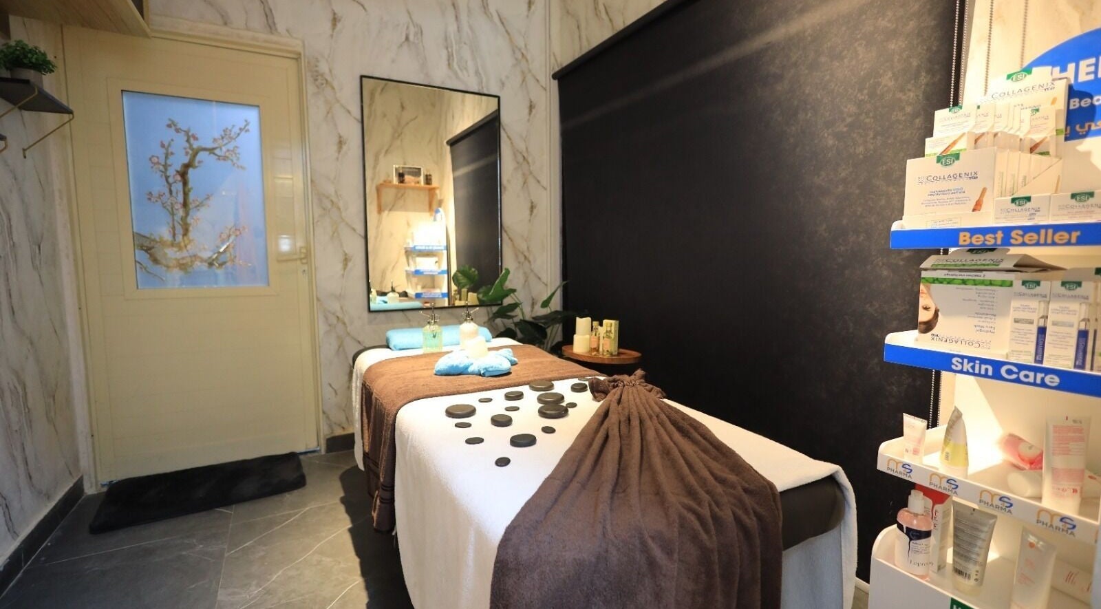 Peaceful therapy room at Leaders Palace Gents Care Facility in Sharjah, Sharjah, AE with massage table and skin care.