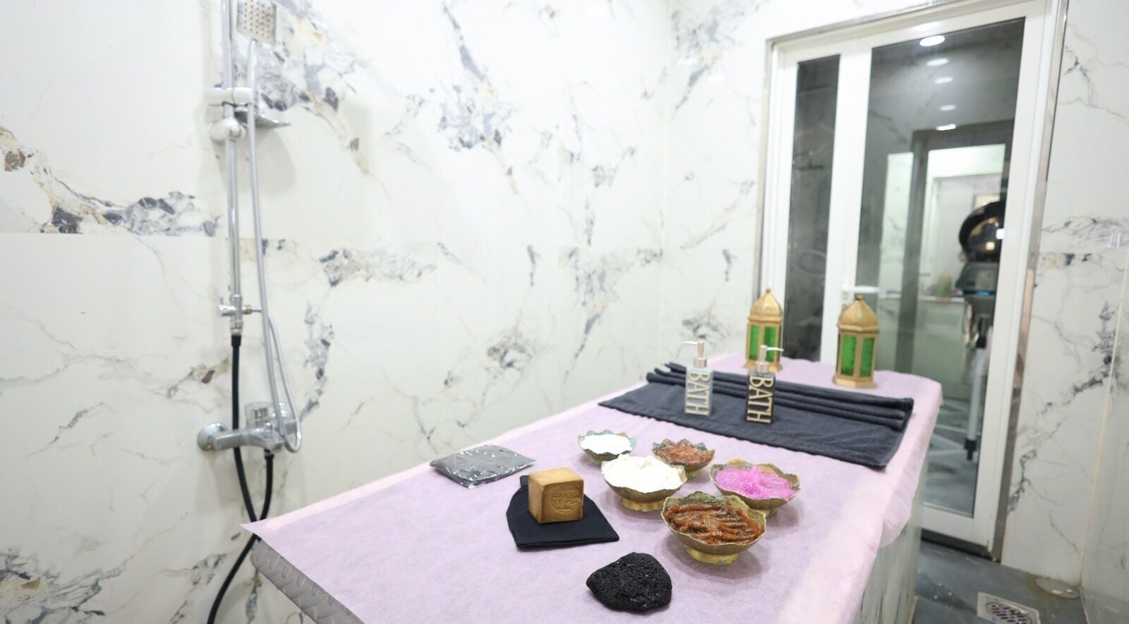 Luxurious spa room at Leaders Palace Gents Care Facility, Sharjah, AE, featuring premium bath essentials.