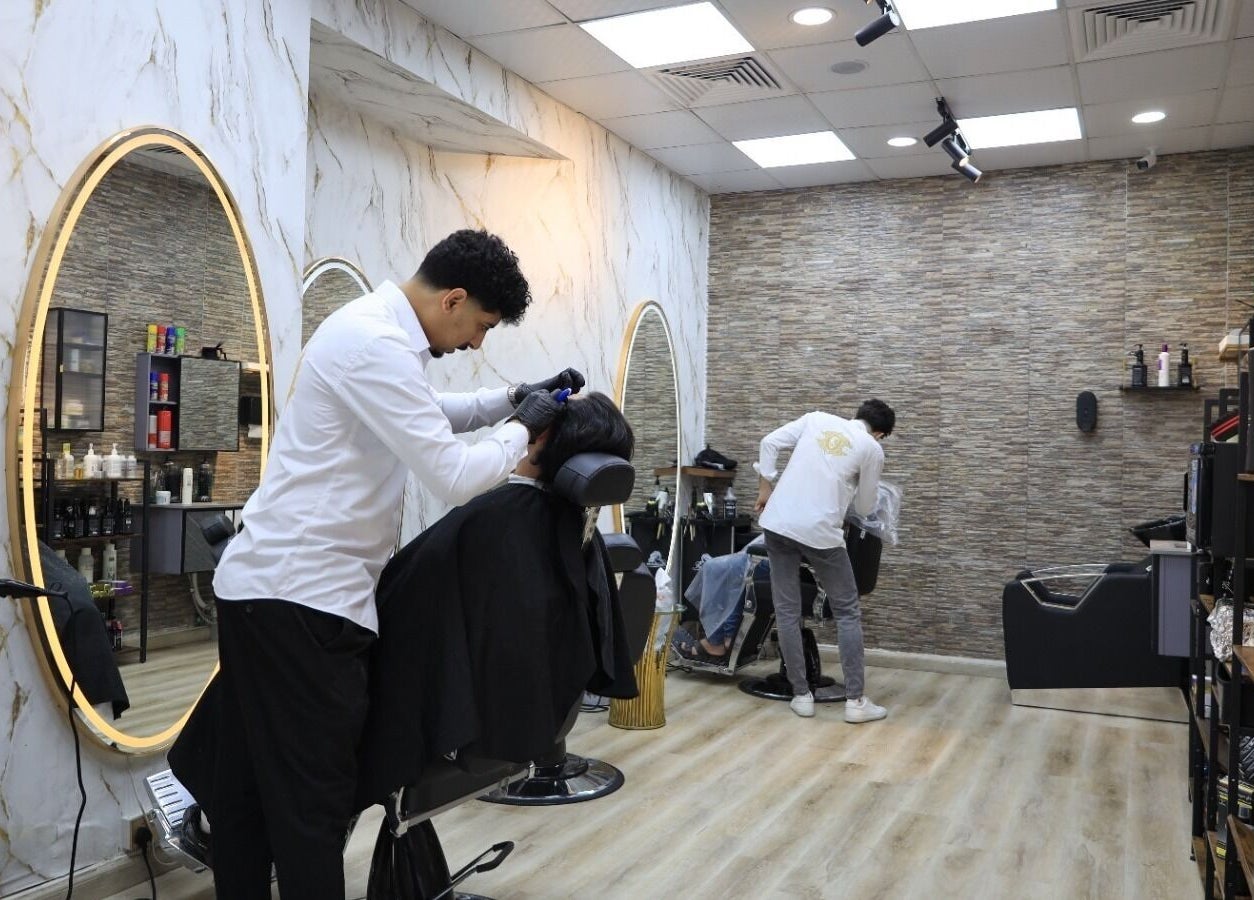Barbers at work inside Leaders Palace Gents Care Facility, sleek interior, Sharjah, Sharjah, AE.