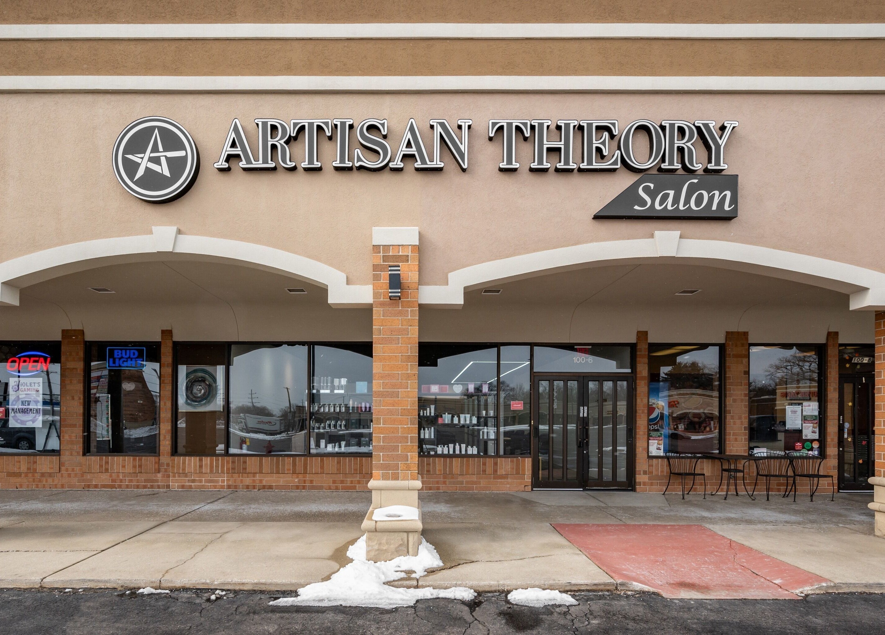 Artisan Theory Salon entrance in Villa Park, Illinois, US, showcasing its modern storefront and logo.