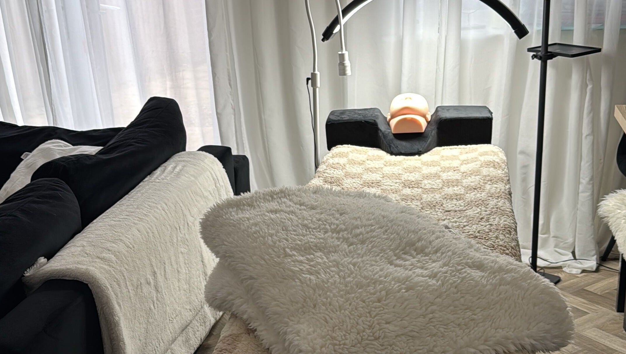 Cozy treatment area at Lusso Lashes, Brockworth, England, GB, featuring padded bed and warm lighting.