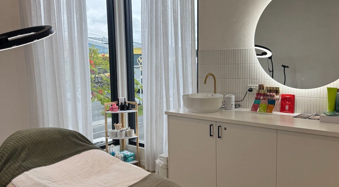 Cozy beauty treatment room at Defined Cosmetics, Labrador, Queensland, AU with soft lighting and elegant decor.