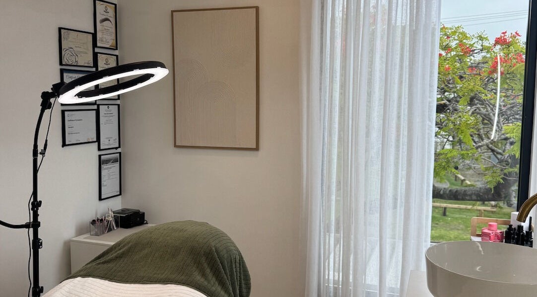 Tranquil beauty treatment room at Defined Cosmetics, Labrador, Queensland, AU, with natural light and modern decor.