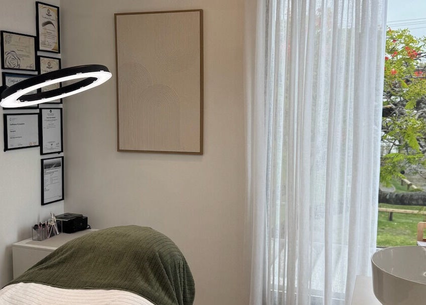 Cozy treatment room at Defined Cosmetics in Labrador, Queensland, AU, featuring soft lighting and elegant decor.