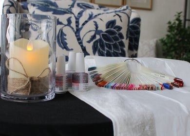 Calming nail setup at I.T Nails - Home Service in Riyadh, Riyadh Province, SA with polish and candle.
