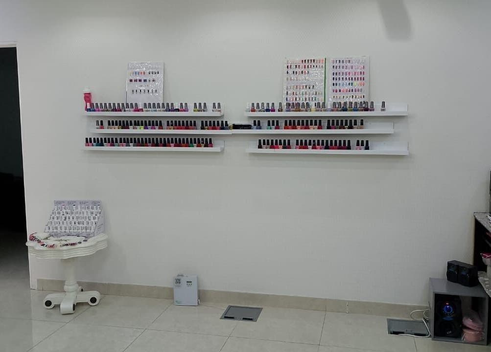 Nail polish shelves at Streaks Ladies Salon - JLT, Dubai, Dubai, AE. Vibrant colors neatly arranged.