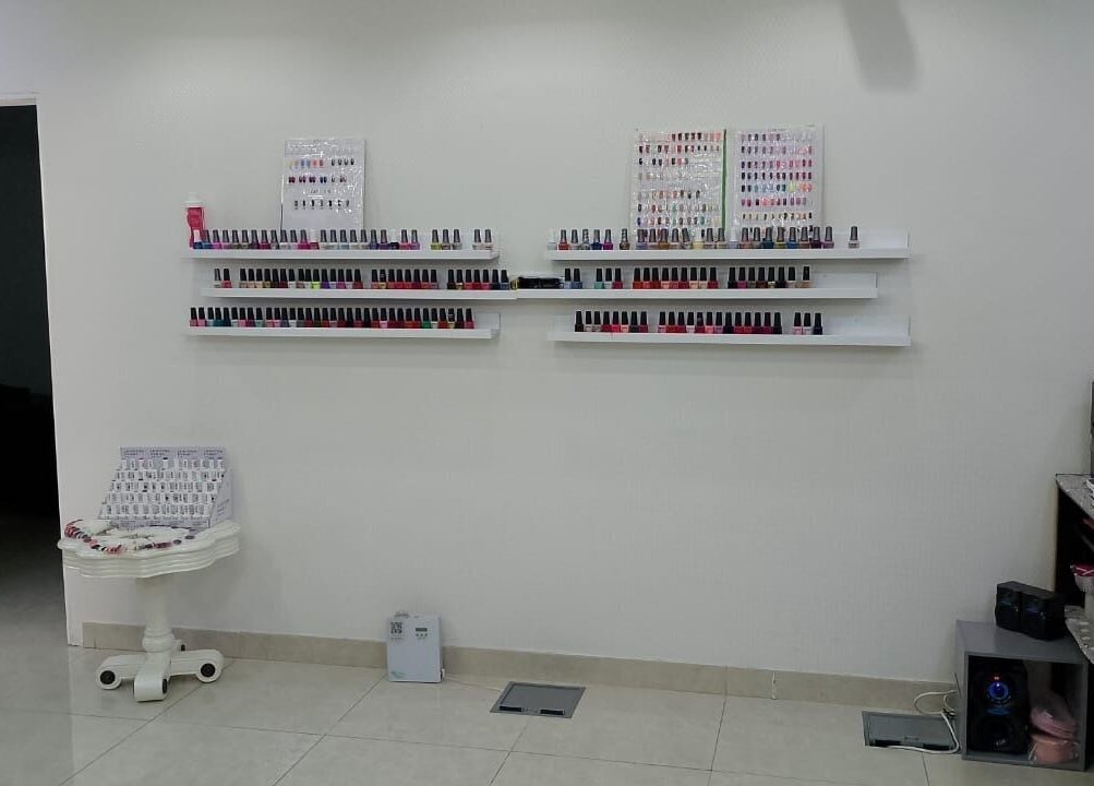 Nail polish shelves at Streaks Ladies Salon - JLT, Dubai, Dubai, AE. Vibrant colors neatly arranged.
