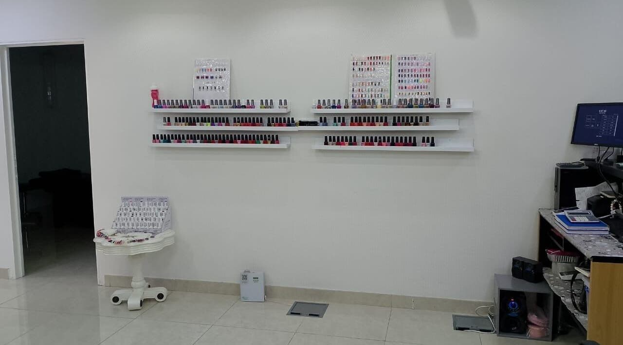 Nail polish shelves at Streaks Ladies Salon - JLT, Dubai, Dubai, AE. Vibrant colors neatly arranged.