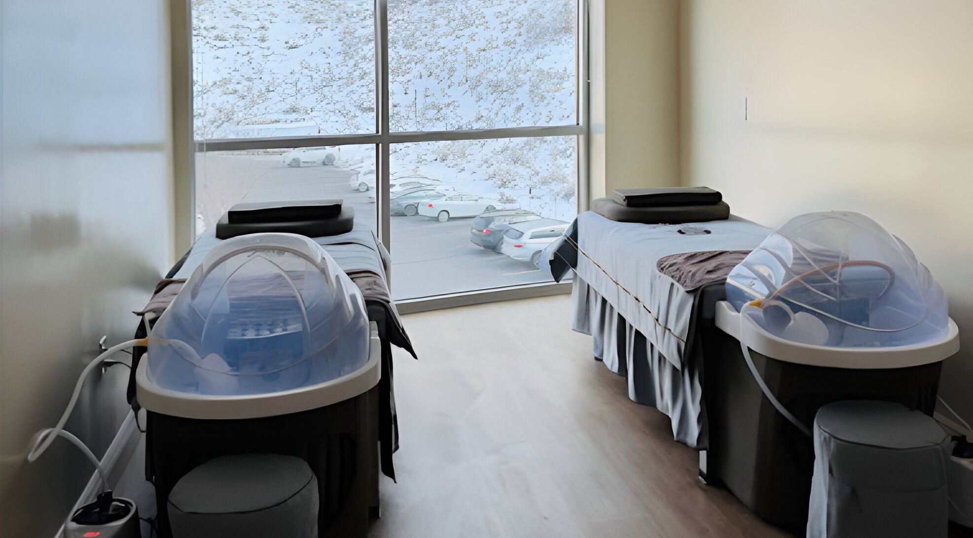 Relaxing spa room at YU HEAD SPA & WELLNESS CENTER, Sandy, Utah, US, featuring two massage tables with a snowy view.
