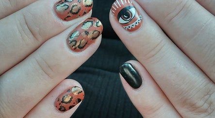 Creative nail art showcasing eye and leopard patterns at Everyday Elegance Spa, West Jordan, Utah, US.