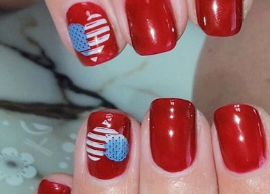 Red manicure with American flag art at Everyday Elegance Spa, West Jordan, Utah, US.