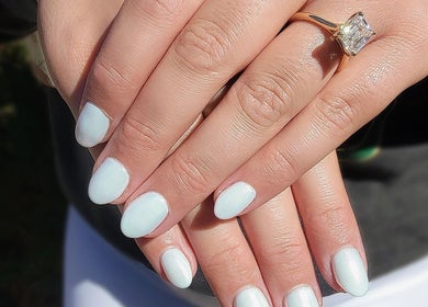 Manicured hands with white polish at Everyday Elegance Spa, West Jordan, Utah, US.