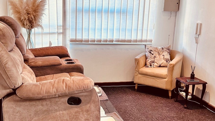 Relaxing lounge area at Serenity Wellness & Beauty Spa, Gqeberha, Eastern Cape, ZA with cozy seating.